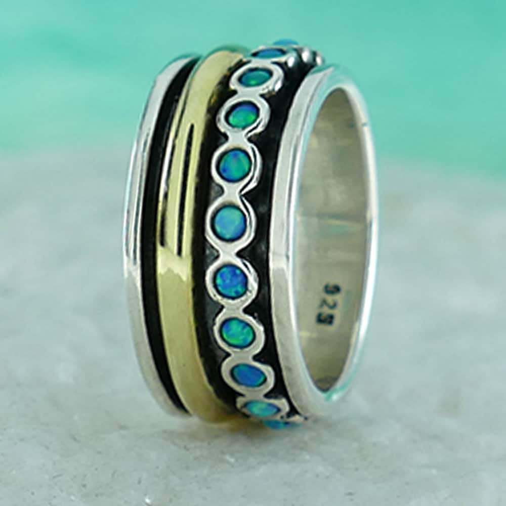 Spinner Ring Blue Opal Stone Two Tone Solid 9k Yellow Gold & 925 Sterling Silver Metal Purity: 9k Main Stone: Doublet Opals Total Carat Weight (TCW): 0.6 Thickness mm: 2 Hight Above The Finger mm: 2 Width mm: 10.5 Weight gr.: 8.6