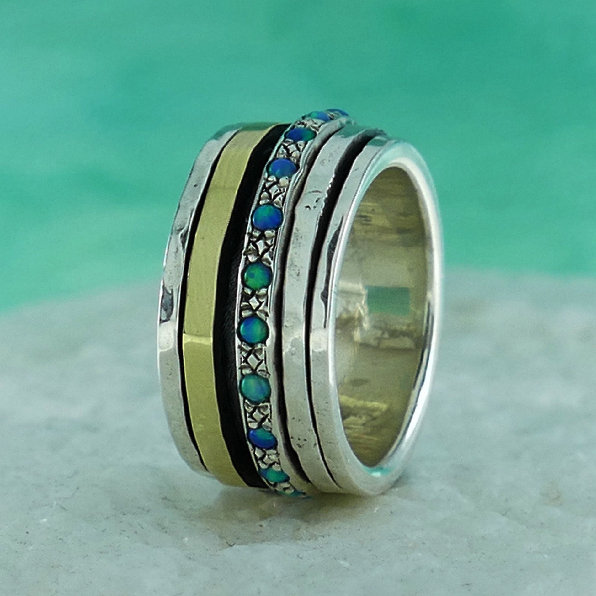 A Symphony of Textures: Unique Silver and Gold Opal Spinner Rings that Engage Your Senses