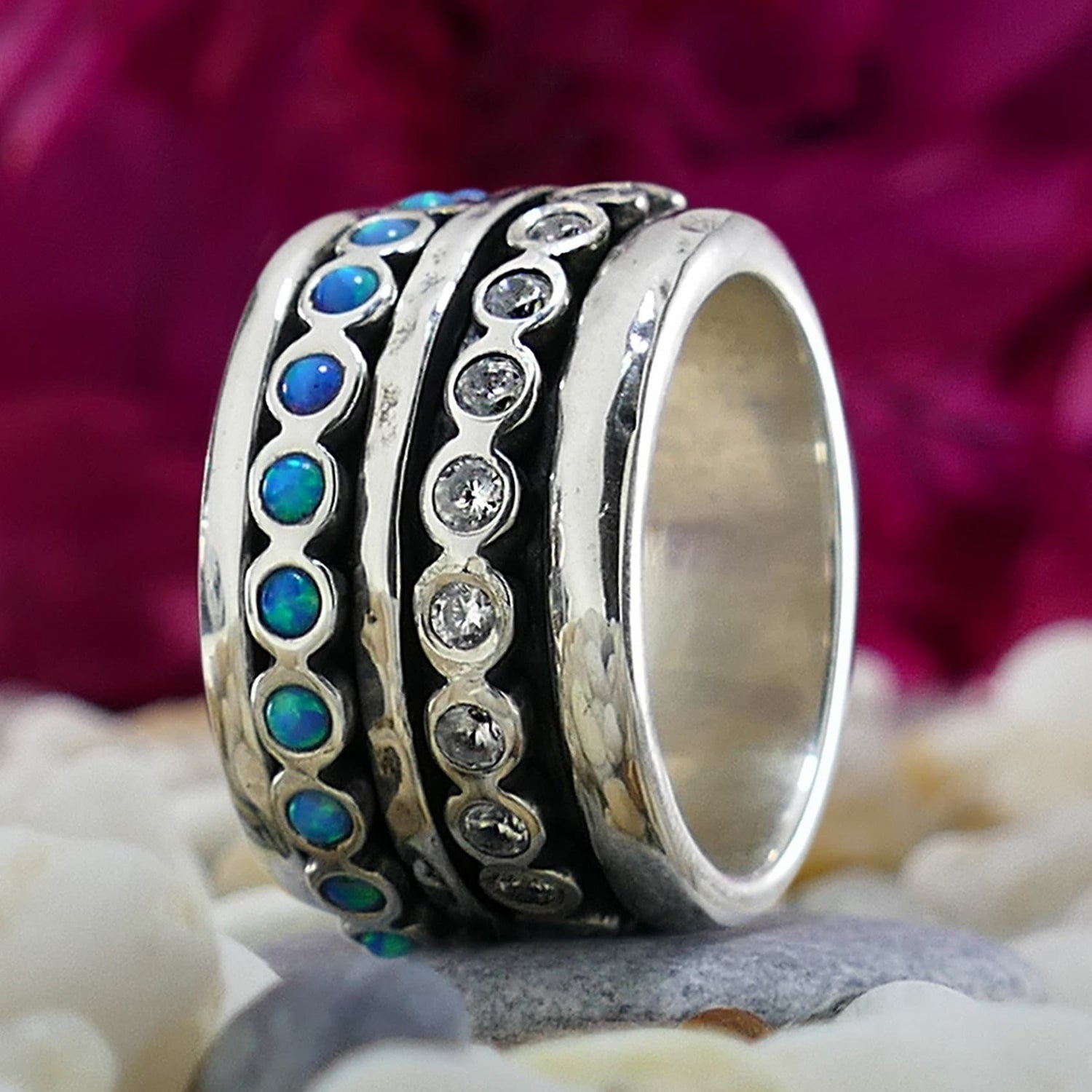 Blue Opal And White Cubic Zirconia Stones 925 Sterling Silver Spinner Ring Spinner rings quantity: 3 Main Stone: Doublet Opals Secondary Stone: Cubic Zirconia Total Carat Weight (TCW): 2.2 Thickness mm: 3 Width mm: 14.5 Weight gr.: 15.4