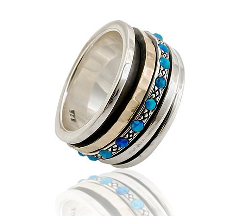 Blue Opal Stone Two Tone Solid 9k Yellow Gold &amp; 925 Sterling Silver Spinner Ring Metal Purity: 9k Spinner rings quantity: 3 Main Stone: Doublet Opals Total Carat Weight (TCW): 0.6 Thickness mm: 3 Width mm: 11.5 Weight gr.: 13.2