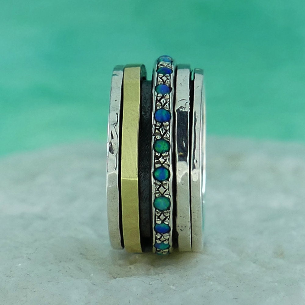 A Symphony of Textures: Unique Silver and Gold Opal Spinner Rings that Engage Your Senses