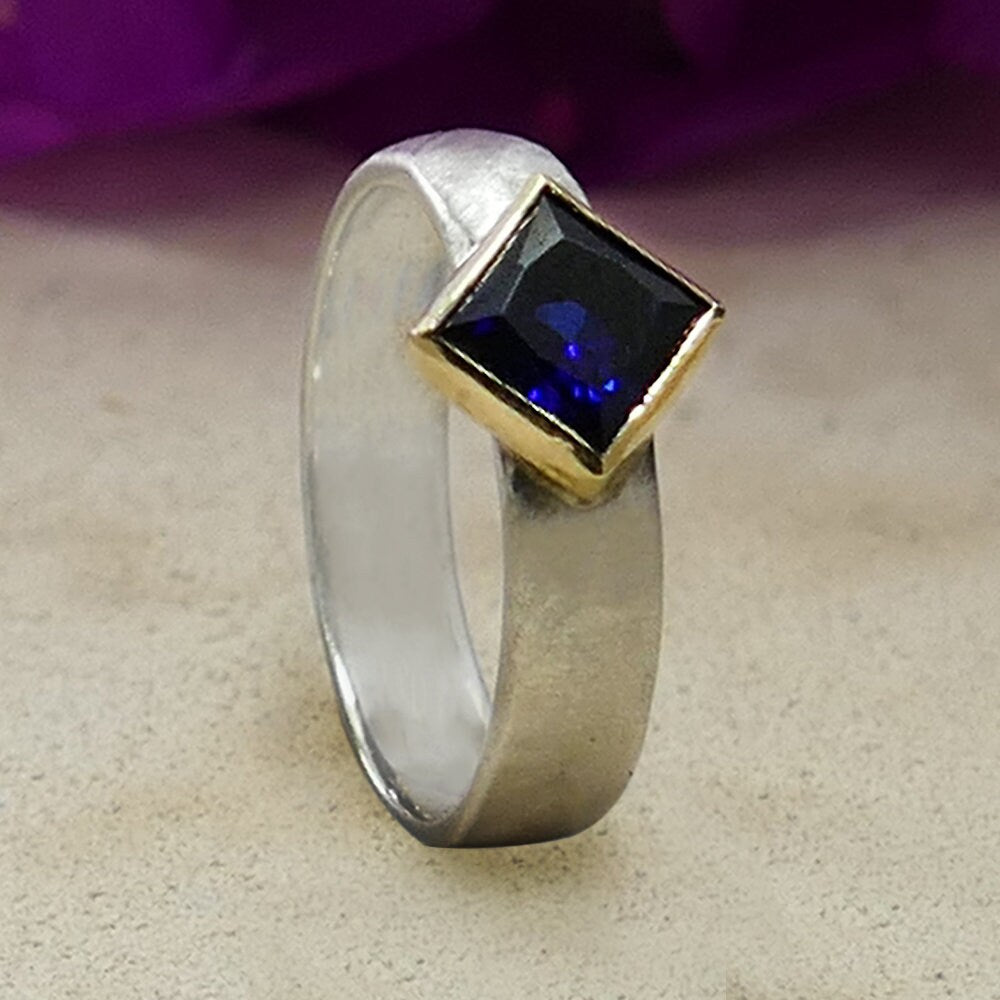 Natural Blue Sapphire Gemstone Two Tone Solid 9k Yellow Gold &amp; 925 Sterling Silver Ring Main Stone: Sapphire Main Stone Creation: Natural Total Carat Weight (TCW): 1.1 Thickness mm: 2 Hight Above The Finger mm: 3.5 Width mm: 5 Weight gr.: 3.3