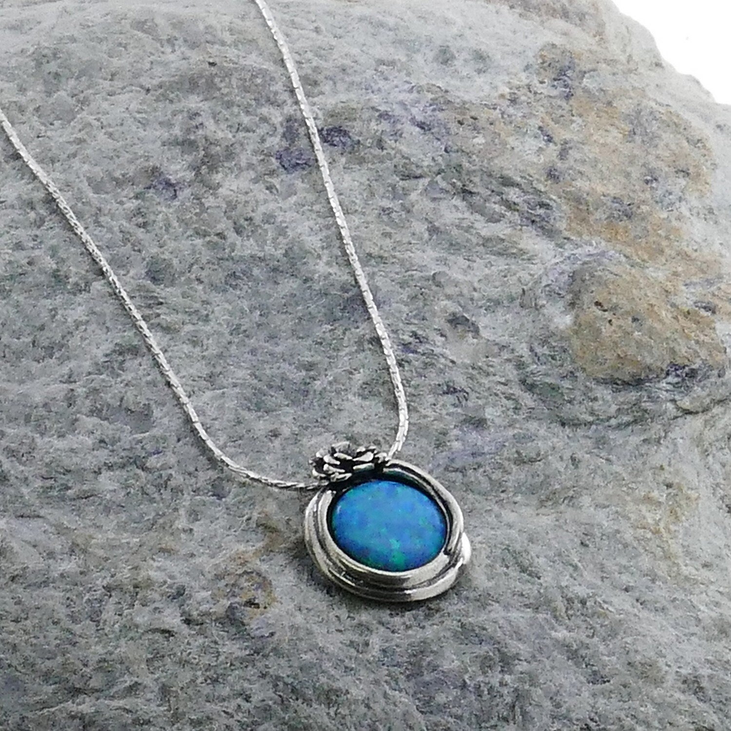 SPIRA Handcrafted 925 Sterling Silver Blue Opal Pendant Style: Pendant Chain Chain Type: Rope Length available: 15-20 inches Metal: 925 Sterling Silver Stone: Opal