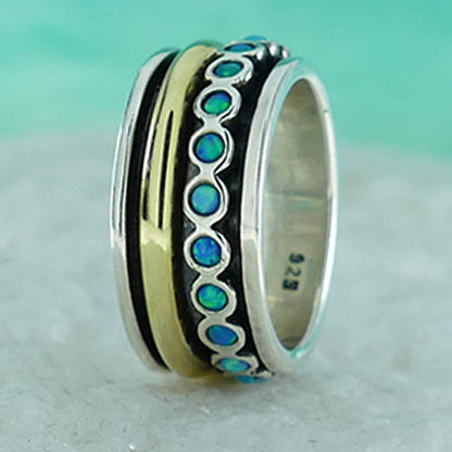 Spinner Ring Blue Opal Stone Two Tone Solid 9k Yellow Gold &amp; 925 Sterling Silver Metal Purity: 9k Main Stone: Doublet Opals Total Carat Weight (TCW): 0.6 Thickness mm: 2 Hight Above The Finger mm: 2 Width mm: 10.5 Weight gr.: 8.6