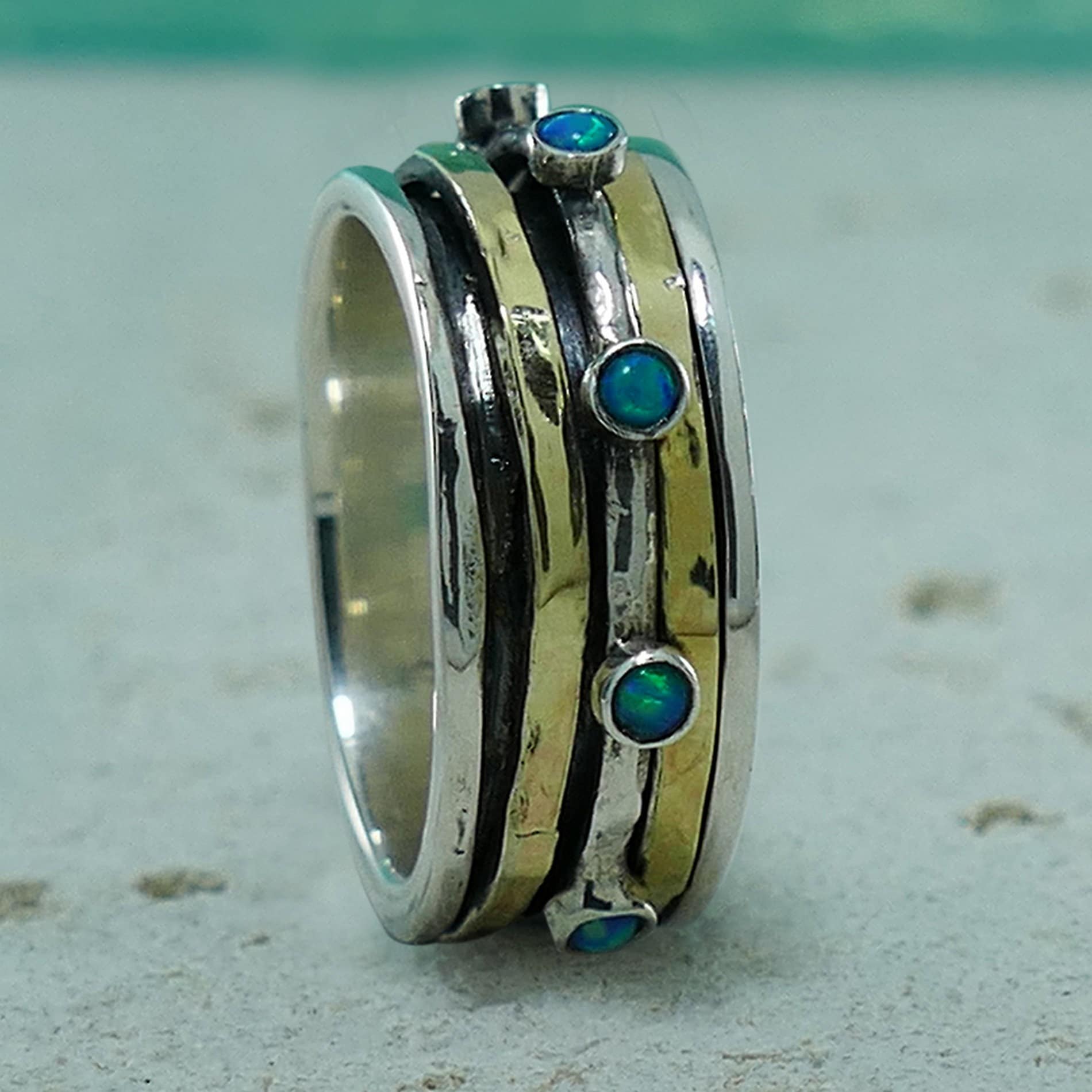 Blue Opal Stone Two Tone Solid 9k Yellow Gold &amp; 925 Sterling Silver Spinner Ring Spinner rings quantity: 3 Main Stone: Doublet Opals Total Carat Weight (TCW): 0.24 Thickness mm: 2 Hight Above The Finger mm: 3 Width mm: 8.5 Weight gr.: 6.6